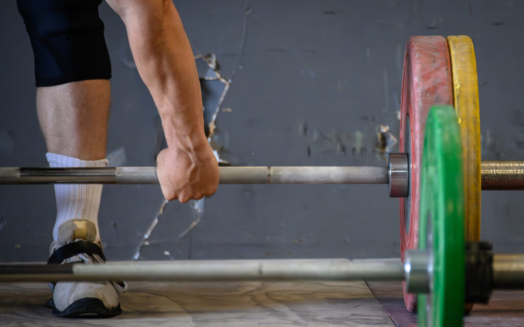 A weightlifter lifts on an Olympic style platform.